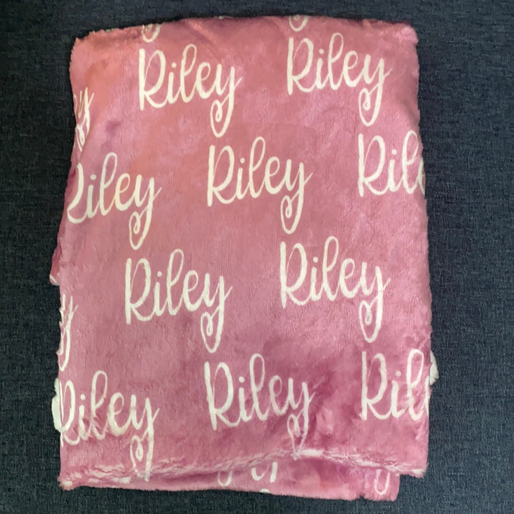 Personalized pink baby blanket with “Riley”